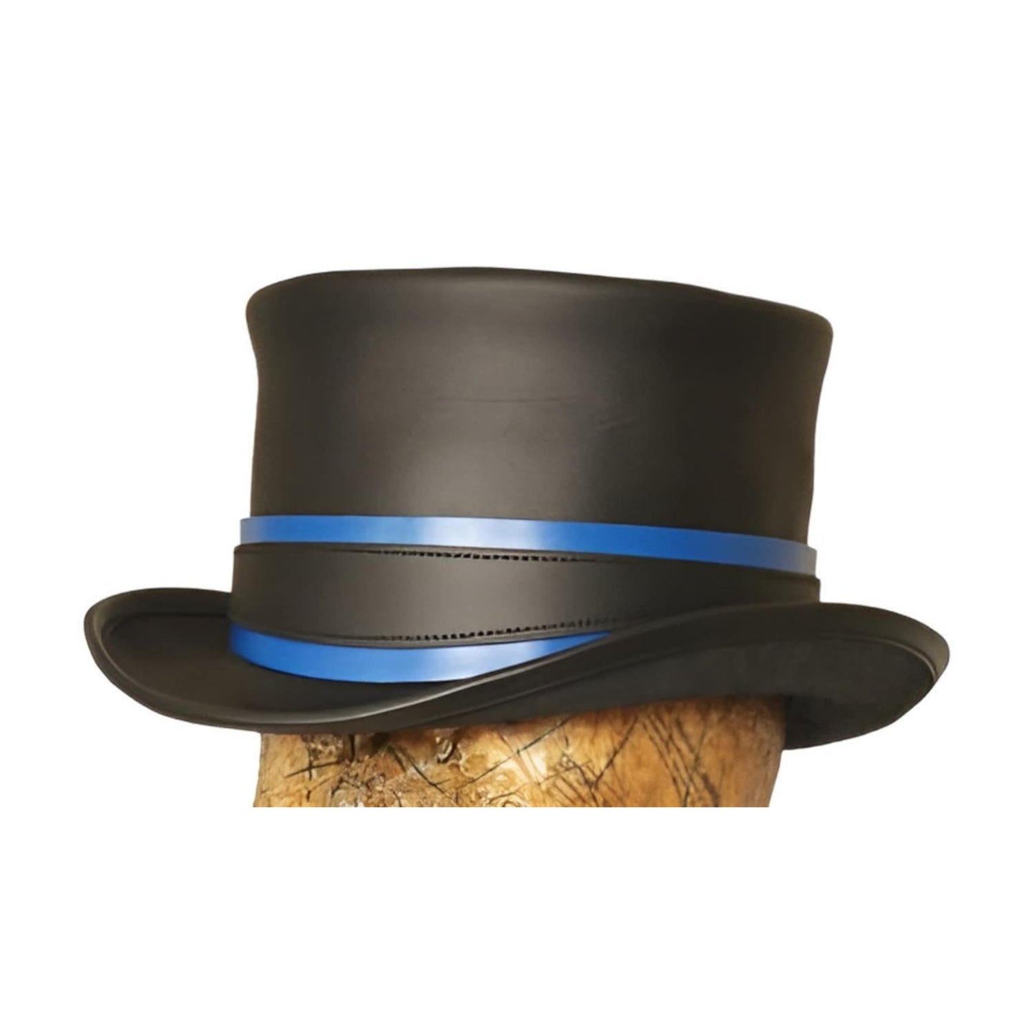 Black top hat with a blue band on a wooden block against a white background