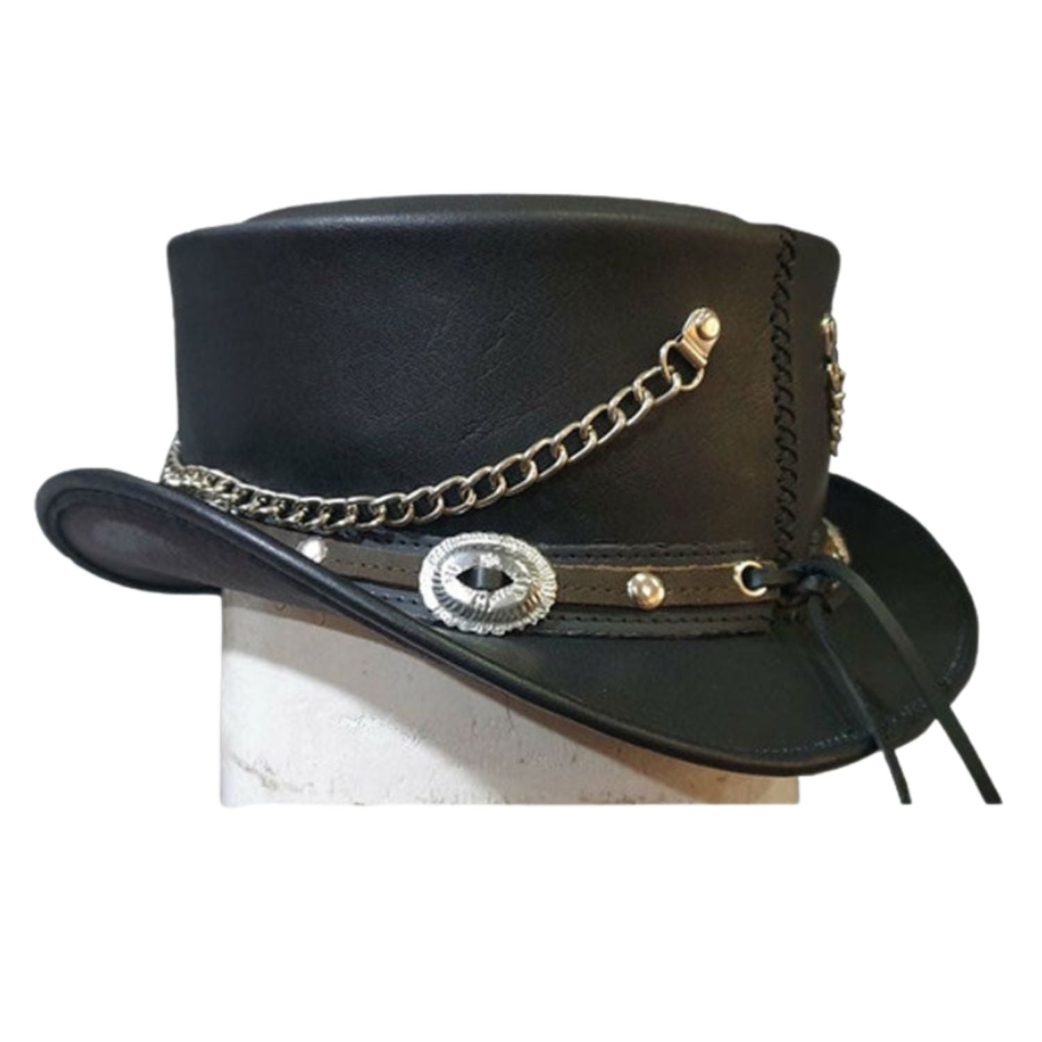 Black leather top hat with a wide brim, decorated with a silver chain, a silver concho-style emblem, and a black leather strap with a tie, displayed on a white block against a white background.